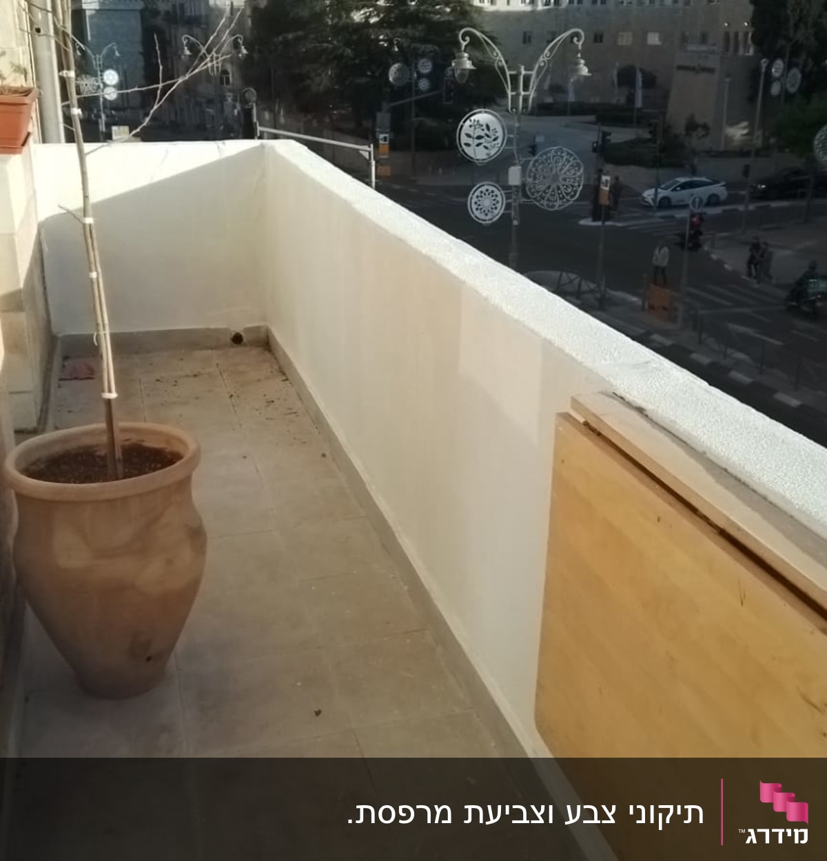 מעקה מרפסת צבוע בלבן עם לוח עץ